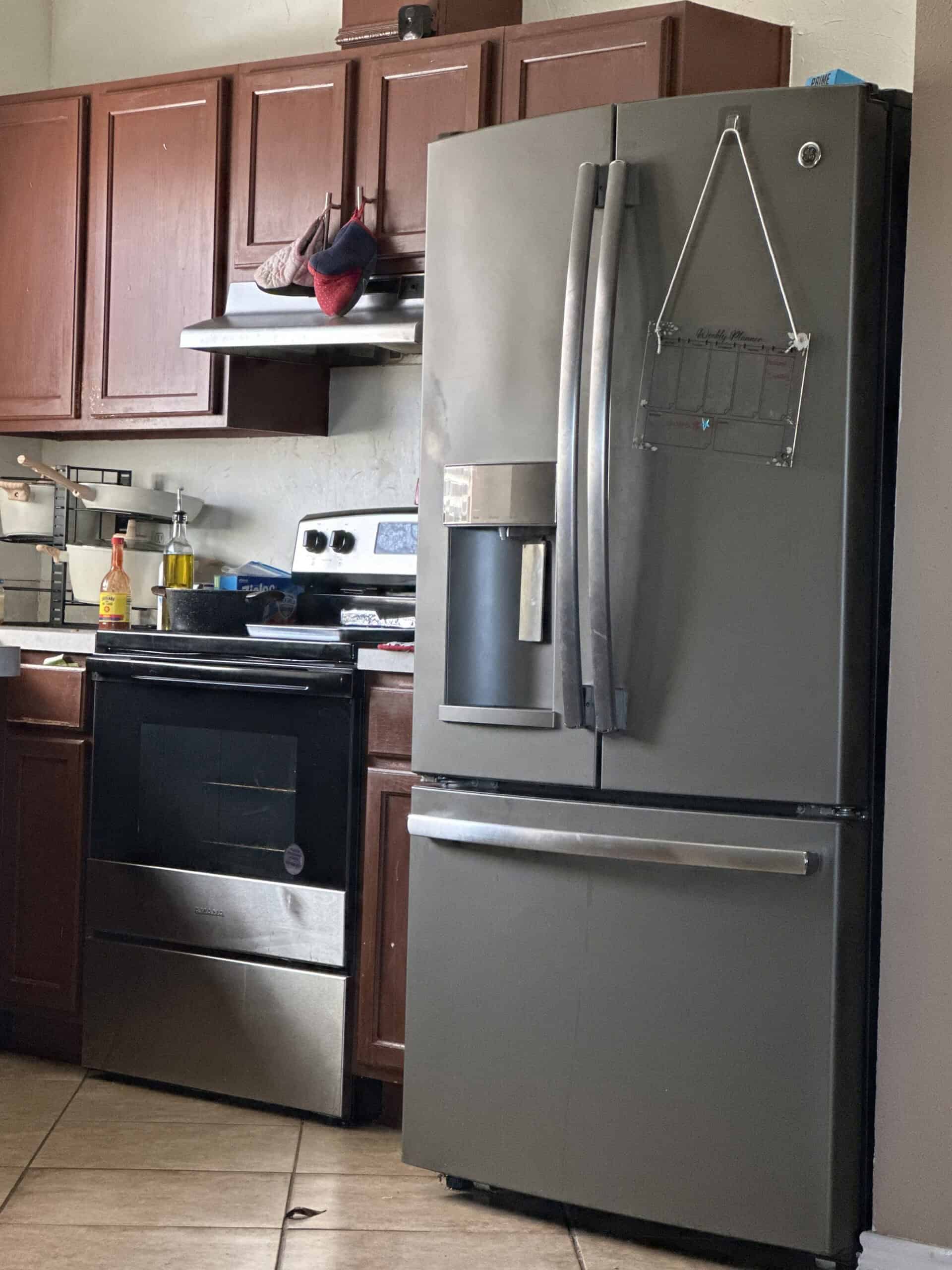 Refrigerator repair technician fixing kitchen fridge in Mesquite TX