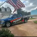 Urban Brothers Appliance Repair branded truck parked in driveway with American flag